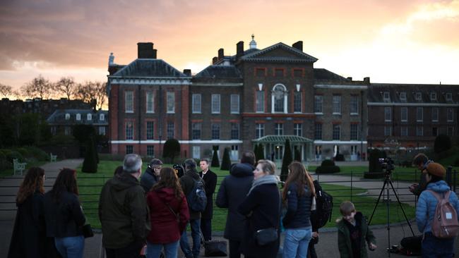 Journalists and bypassers gather outside Kensington Palace in London after Catherine’s announcement. Picture: AFP.