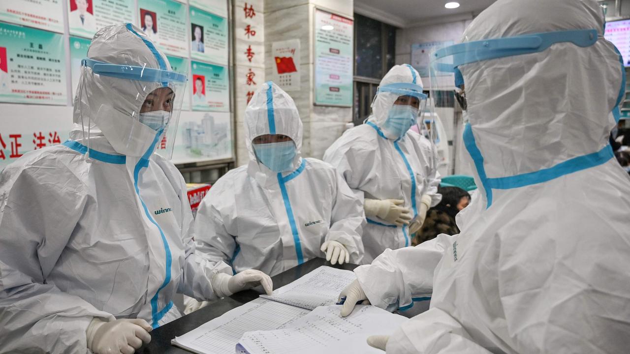 TOPSHOT - Medical staff members work at the Wuhan Red Cross Hospital. Picture: Hector Retamal/AFP