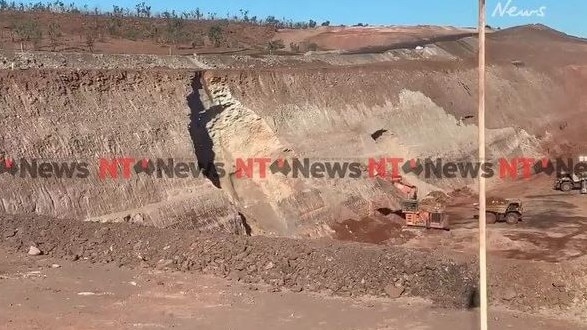 Video sent to the NT News has captured a pit wall collapsing at a mine. The avalanche of rock and soil came dangerously close to earth moving machinery, which was covered in a cloud of dirt. Picture: Supplied