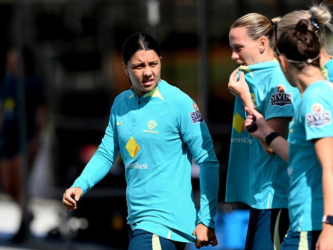 BRISBANE, AUSTRALIA - AUGUST 04: Sam Kerr (L) speaks with team mates Emily Van-Egmond and Caitlin Foord during an Australia Matildas training session at the FIFA Women's World Cup Australia & New Zealand 2023 at Queensland Sport and Athletics Centre on August 04, 2023 in Brisbane, Australia. (Photo by Bradley Kanaris/Getty Images)