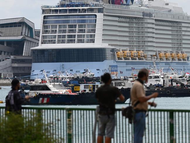 The Royal Carribean International cruise ship Quantum of the Seas (C) is docked at Marina Bay Cruise Centre in Singapore on December 9, 2020. (Photo by Roslan Rahman / AFP)