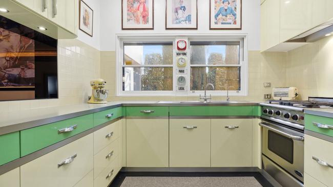 Custom 2pac cabinetry and soft-close drawers feature in the kitchen.