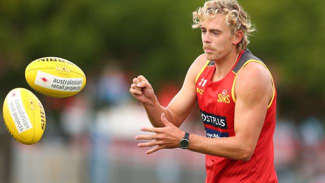 GOLD COAST, AUSTRALIA - Hugh Greenwood handballs during a Gold Coast Suns AFL training session at Metricon Stadium, 2020 in Gold Coast, Australia. (Photo by Chris Hyde/Getty Images)