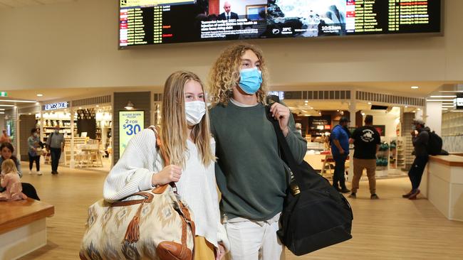 Cairns Airport has created a business plan to map out a path to recovery once the national Covid-19 vaccination rate reaches 70 and 80 per cent, and state borders open freely to tourism. Adelaide tourists Katie Cook and Anton Talladira arrived at Cairns Airport for a week long holiday in Cairns and the Daintree rainforest. Picture: Brendan Radke