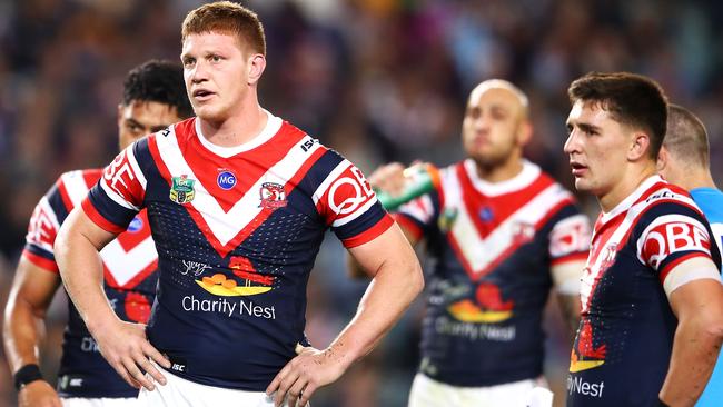 Dylan Napa of the Roosters looks dejected as he watches on during the Round 24 NRL match against the Broncos. Photo: Getty Images