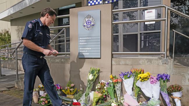 Shane Patton lays a tribute at Boroondara Police Station in Kew near the scene of the crash.