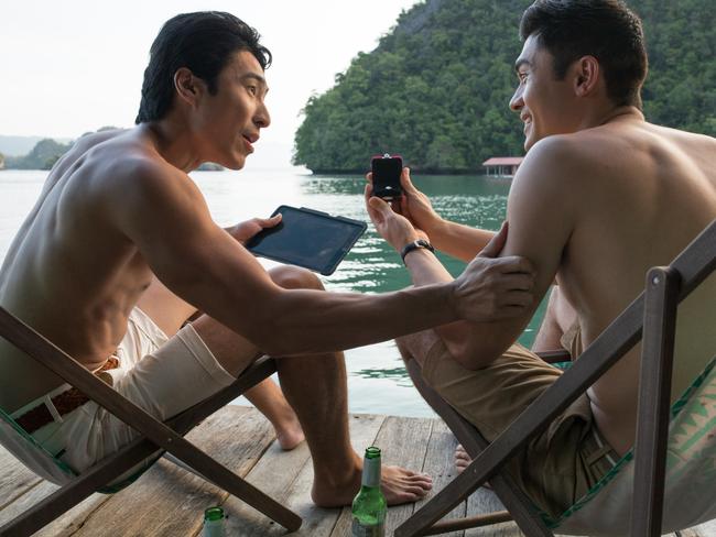 Chris Pang (left) with Henry Golding in a scene from the box office hit Crazy Rich Asians. Picture: Sanja Bucko