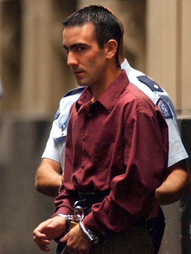 Jason Roberts is taken to a waiting prison van after being found guilty in 2002. Picture: Joe Castro