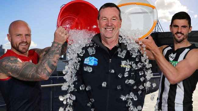 Melbourne captain Nathan Jones and Collingwood captain Scott Pendlebury tip ice on Neale Daniher ahead of the Big Freeze 3 at the MCG. Picture: Michael Klein