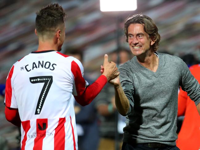 BRENTFORD, ENGLAND - JULY 29: Thomas Frank (R), head coach of Brentford celebrate with team mate Sergi CanÃÂ³s after the Sky Bet Championship Play Off Semi-final 2nd Leg match between Brentford and Swansea City at Griffin Park on July 29, 2020 in Brentford, England. Football Stadiums around Europe remain empty due to the Coronavirus Pandemic as Government social distancing laws prohibit fans inside venues resulting in all fixtures being played behind closed doors. (Photo by Catherine Ivill/Getty Images)