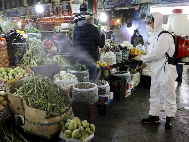 A firefighter disinfects a traditional shopping centre to help prevent the spread of the new coronavirus in northern Tehran, Iran. Picture: AP Photo/Ebrahim Noroozi