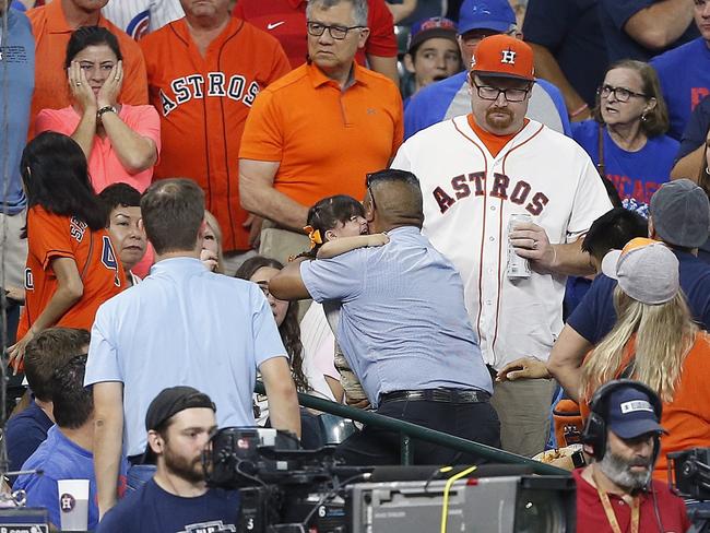 A young child is rushed from the stands after being injured by a hard foul ball off the bat of Albert Almora Jr. Picture: Bob Levey/Getty Images/AFP