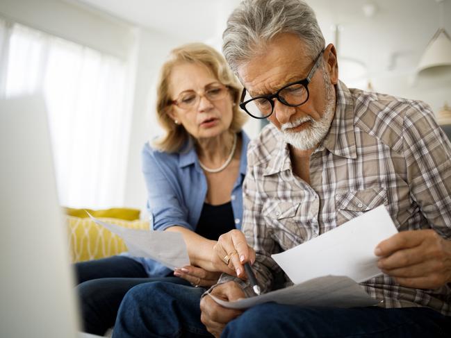 Shot of a senior couple looking stressed while going over their finances at home; wealth superannuation worries generic bills