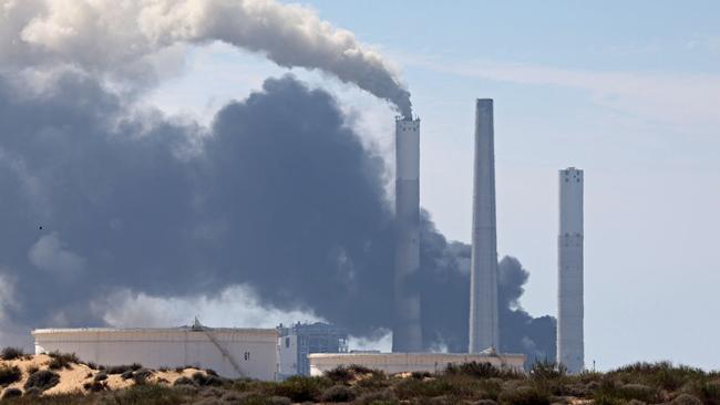 Smoke billows from a power station in Ashkelon on October 7, as barrages of rockets were fired from the Palestinian enclave into Israeli territory.