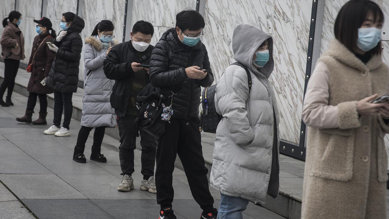 People waiting to enter Wuhan international plaza on March 30. Picture: Getty Images