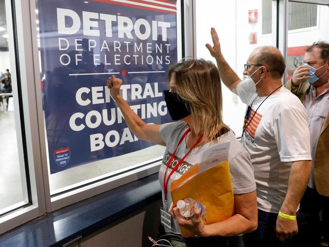 Donald Trump supporters bang on the glass and chant slogans outside the room where absentee ballots for the 2020 general election are being counted in Detroit. Picture: AFP