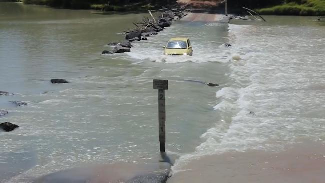 Car meets crocodile on the infamous Cahills Crossing