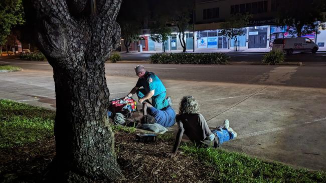 St John Ambulance NT's director of ambulance services Andrew Thomas treats Vera at Stuart Park as Sammy watches on. Picture: Alex Treacy