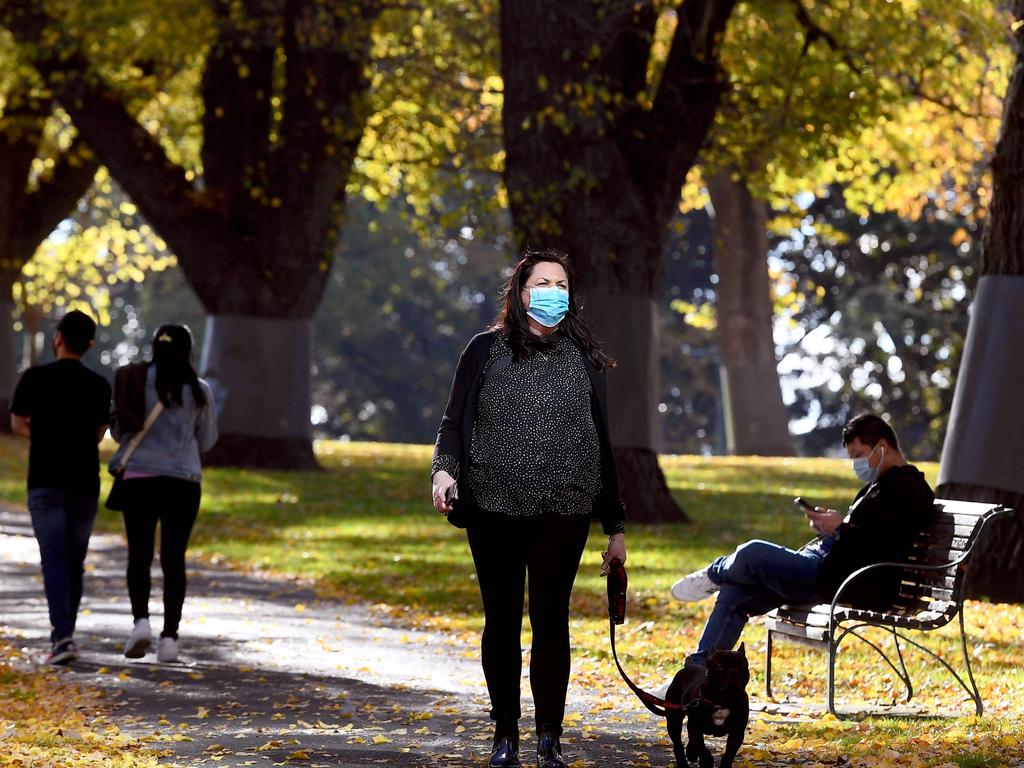 People walk through an inner-city park in Melbourne during lockdown. Pictures: William West/AFP