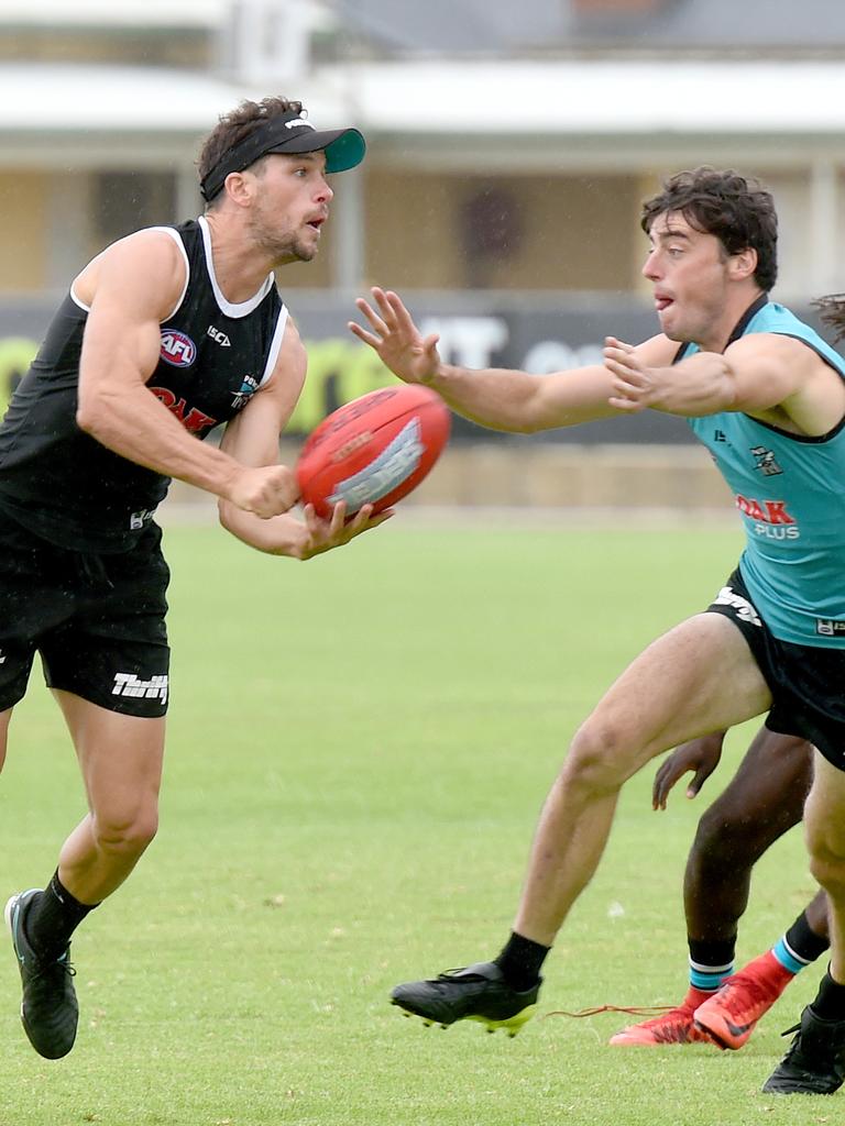 Former captain Travis Boak fires off a handpass at Port Adelaide training at Alberton. Picture: Naomi Jellicoe