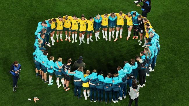 Matildas players and staff in a huddle following the semi-final loss. Picture: Getty Images