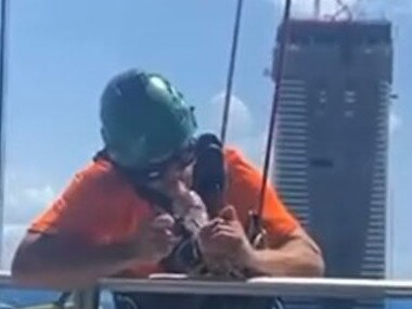 TikTok tradie smokes bong while hanging from high-rise