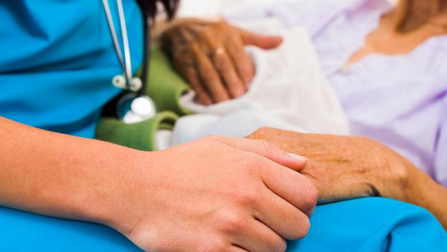 Social care provider holding senior hands in caring attitude – helping elderly people. Picture: iStock