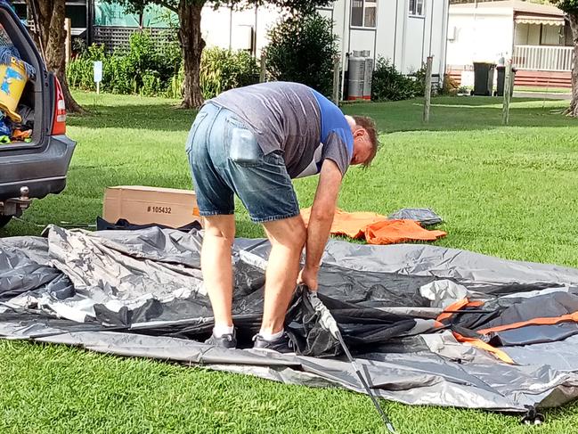 Peter putting up their tent.