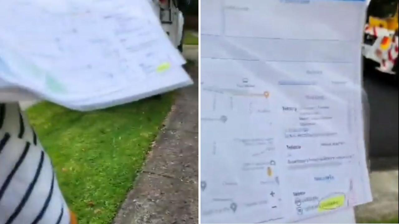 The woman waved a plastic sleeve with sheets of supposed evidence at the tradie. Picture: Twitter