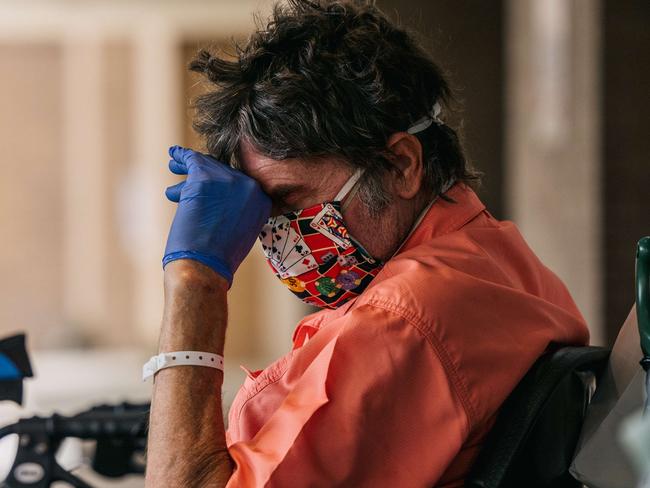 HOUSTON, TEXAS - JULY 16: A man sits with his head down while waiting to depart the Houston Methodist Hospital on July 16, 2021 in Houston, Texas. As of mid-April, the Houston Methodist Hospital has identified and treated the Delta variant; a mutation of COVID-19. The Houston metropolitan area has seen an upward increase of Delta infections, and research is showing the Delta variant to be 60% more contagious then its predecessor the Alpha variant, also known as COVID-19.   Brandon Bell/Getty Images/AFP == FOR NEWSPAPERS, INTERNET, TELCOS & TELEVISION USE ONLY ==