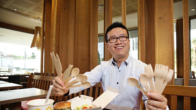 McDonald’s Haberfield supervisor Shao Chen with the fast food outlet’s new wooden cutlery. Picture: Adam Yip