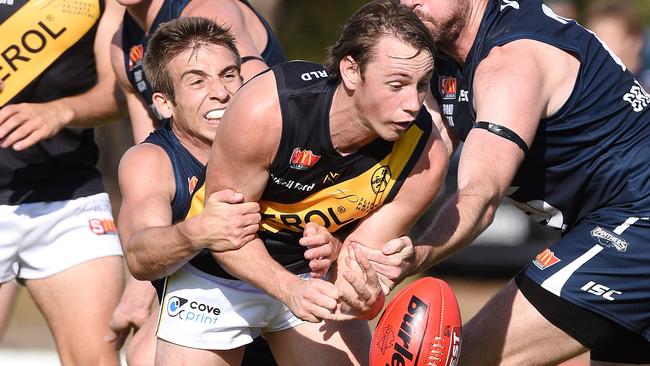 South's Joel Cross tackles Glenelg’s Alex Martini. Picture Roger Wyman