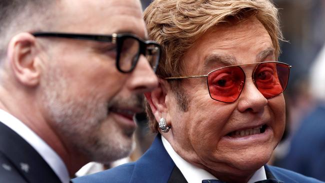 TOPSHOT - English singer-songwriter Elton John (R) and his husband Canadian producer David Furnish pose on the red carpet upon arriving for the UK premiere of the film Rocketman in London on May 20, 2019. (Photo by Adrian DENNIS / AFP)