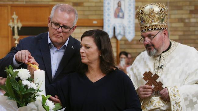 Scott and Jenny Morrison at a service by Reverend Simon Ckuj at St Andrew's Ukrainian Catholic Church in Lidcombe, western Sydney, on Sunday. Picture: Getty Images