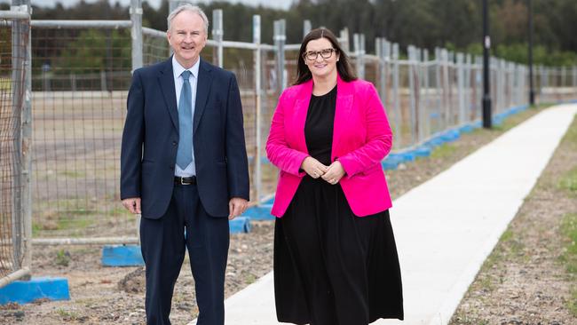 Education Minister Sarah Mitchell and local MP Kevin Connolly with local parents at a new school site in Nirimba Fields, in Sydney's western suburbs. Sarah and Kevin walking along the fence line of the site.