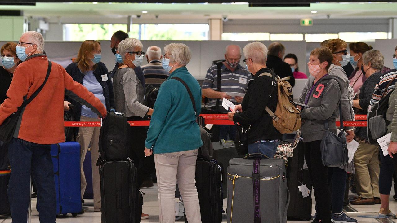 Passengers wait at the check-in for New Zealand flights at Sydney International Airport on the first day of the trans-Tasman quarantine-free travel bubble. Picture: Saeed Khan/AFP