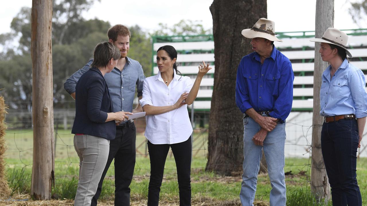 Prince Harry and Meghan in the hay shed at the Mountain View farm in Dubbo. Picture: Dean Lewins/AFP