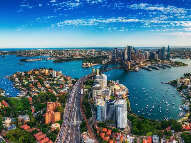 Panorama Aerial view Scene of Crowded Traffic over Express way heading to Sydney Harbour Bridge with Opera House, Lavender bay with many Yacht and Circular Quay in Downtown District of Sydney, Australia, Travel destination and Transportation.Escape 9 February 2025Cover storyPhoto - Getty Images