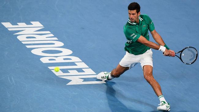 Novak Djokovic hitting a return at the Australian Open in 2021. His visa revoked for failing to meet the country's tough pandemic restrictions. A court is set to hear his legal challenge against his visa cancellation on January 10. (Photo by William WEST / AFP)