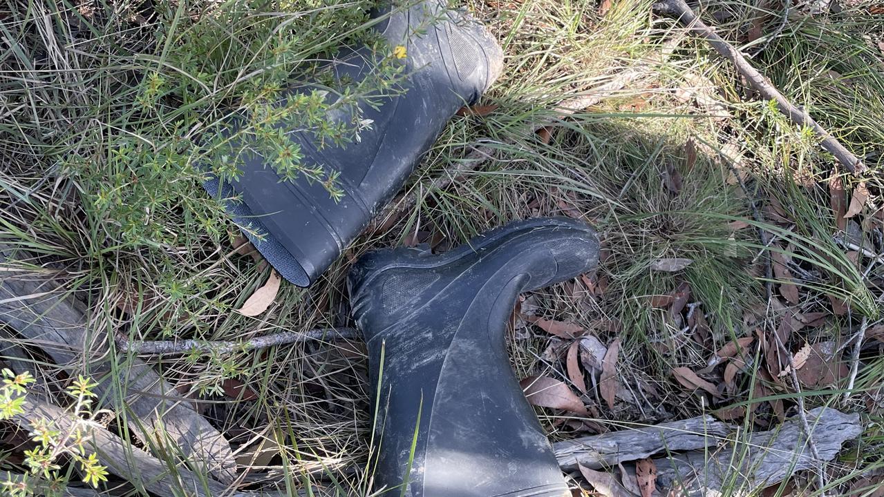 Mary Allen changes into gumboots for the 1.3km trek to her house.