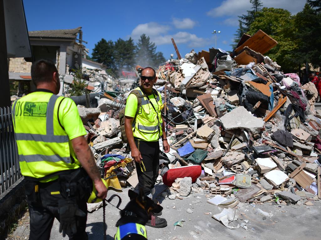 AMATRICE, ITALY - AUGUST 25: Emergency workers search buildings that were destroyed during an earthquake on August 25, 2016 in Amatrice, Italy. The death toll in the 6.2 magnitude earthquake that struck around the Umbria region of Italy in the early hours of Wednesday morning has risen to at least 247 as thousands of rescuers continue to search for survivors. (Photo by Carl Court/Getty Images)