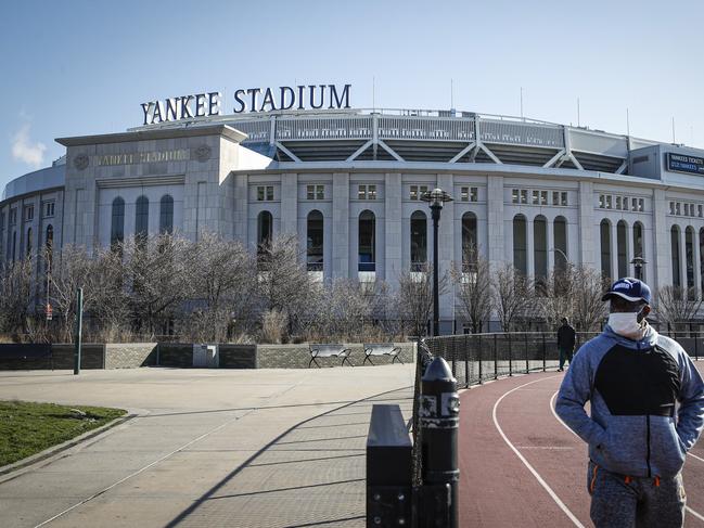 A pedestrian walks near Yankee Stadium as it remains closed due to COVID-19 concerns in New York. Picture: AP