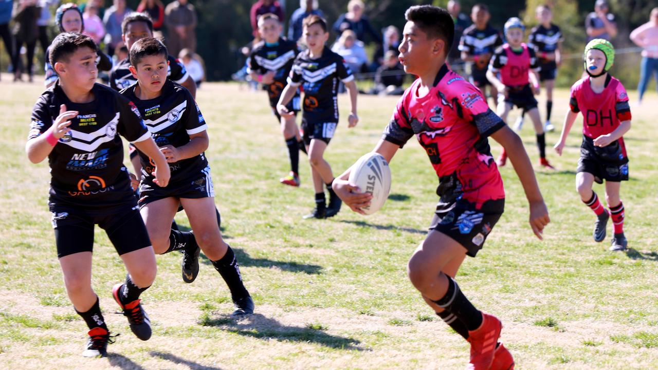 Rouse Hill Rhinos player Ziyon Lepolo runs the ball at the Rouse Hill Rhinos Pink Day (AAP IMAGE / Angelo Velardo)