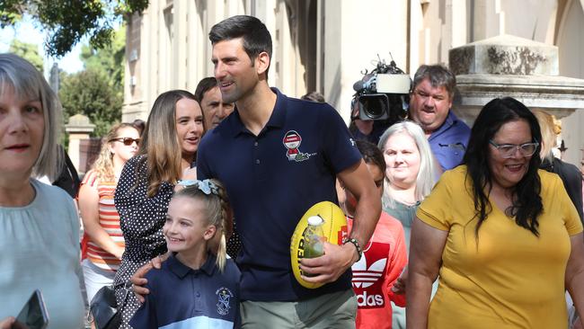 Novak Djokovic was mobbed by media and fans in Wellington Square, North Adelaide, after his quarantine ended at Majestic Suites. Picture: NCA NewsWire/Dean Martin