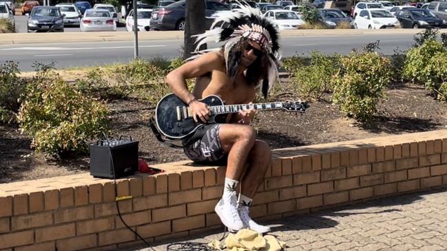 Savas Caruso plays guitar outside of the Elizabeth Magistrates Court in April. Picture: Jason Katsaras