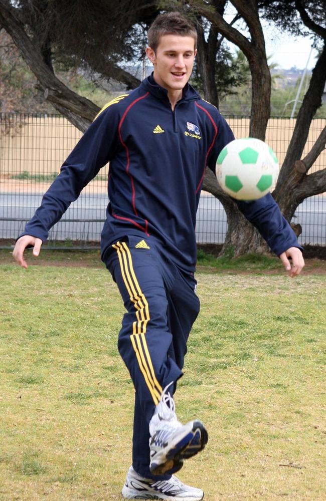 Ivan Maric practises his foot skills while visiting a South Australian school with the Adelaide Crows.