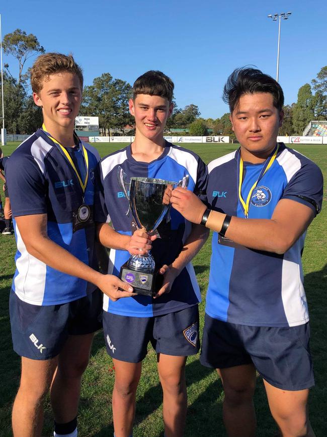 Three A.B. Paterson schoolmates raised the Radio Metro U17’s Grand Final Cup for Helensvale Hogs but only Leon Dang (R) remains after Noah Fielding and Jaxon Arnold were recruited by other schools. Picture: Supplied