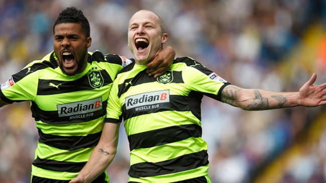 LEEDS, ENGLAND — SEPTEMBER 10: Aaron Mooy of Huddersfield Town celebrates with Elias Kachunga of Huddersfield Town after scoring to make it 0-1 during the Sky Bet Championship match between Leeds United and Huddersfield Town at Elland Road on September 10, 2016 in Leeds, England. (Photo by Robbie Jay Barratt — AMA/Getty Images)