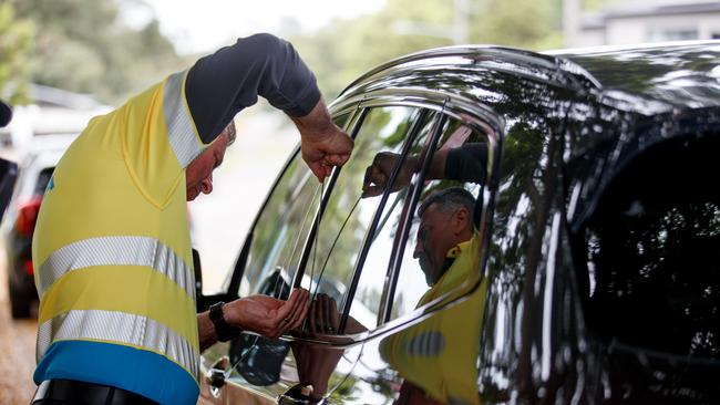 An NRMA patrol member deals with one of the more common problems drivers face – keys locked inside the car. Picture: Nikki Short