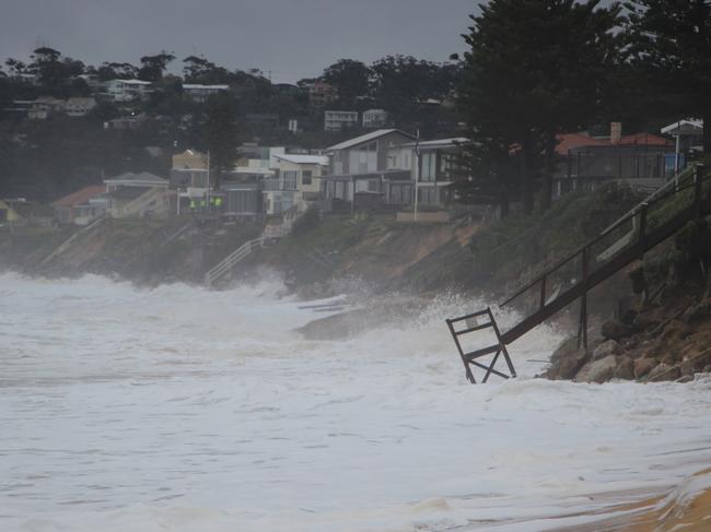 High tide hits Wamberal Beach this afternoon as residents watch on helplessly. Picture: Fiona Killman